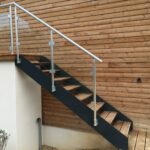 Escalier extérieur en bois avec limons et marches en pin traité menant à une terrasse de jardin